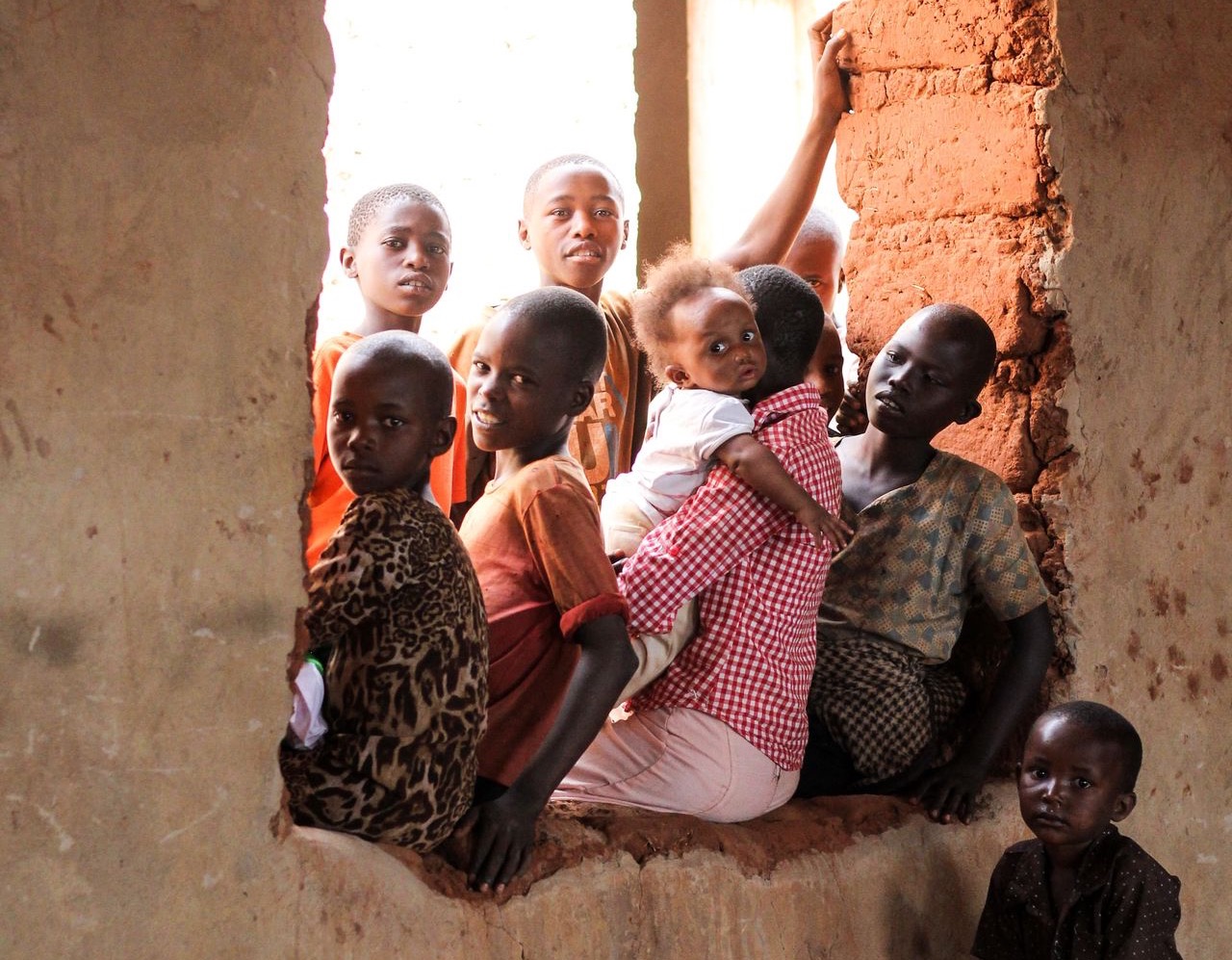 children sitting on window